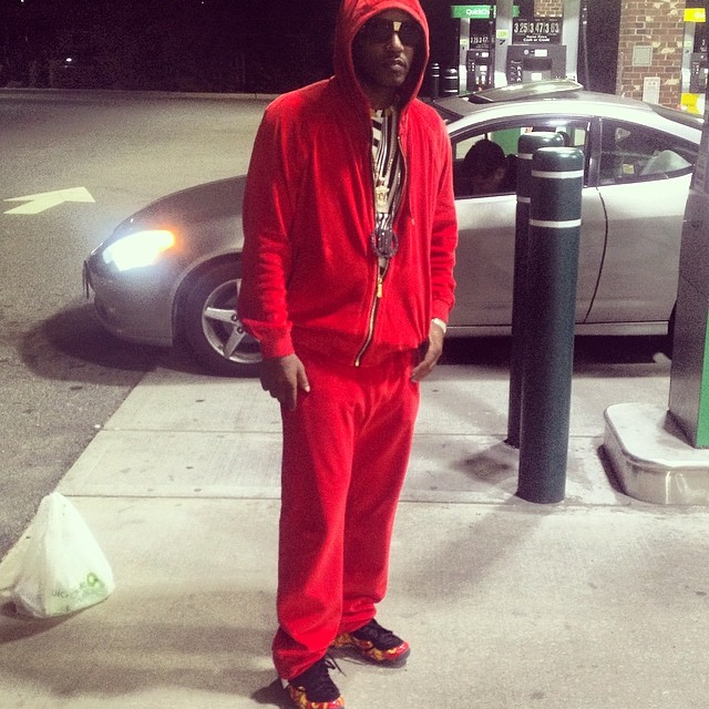 Cam'ron wearing Supreme x Nike Air Foamposite One Red