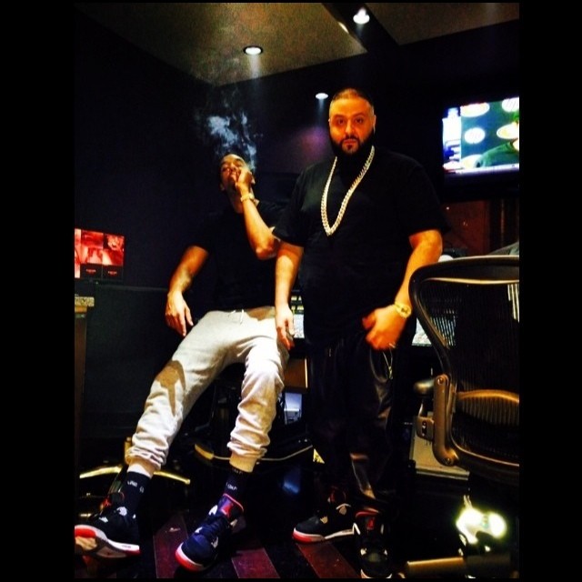 DJ Khaled wearing Air Jordan 4 Black/Cement