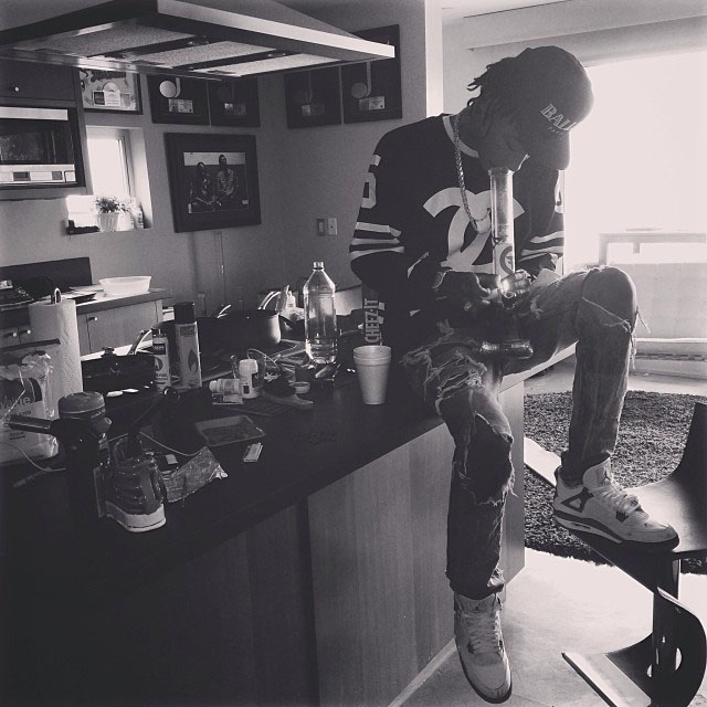 Wiz Khalifa wearing Air Jordan 4 Retro Cement