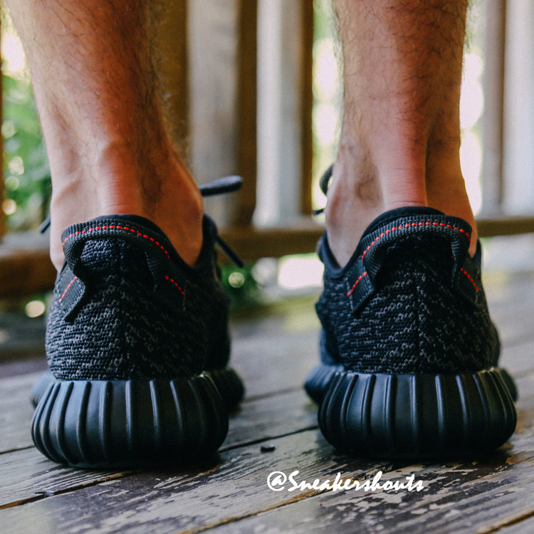 black yeezys on feet