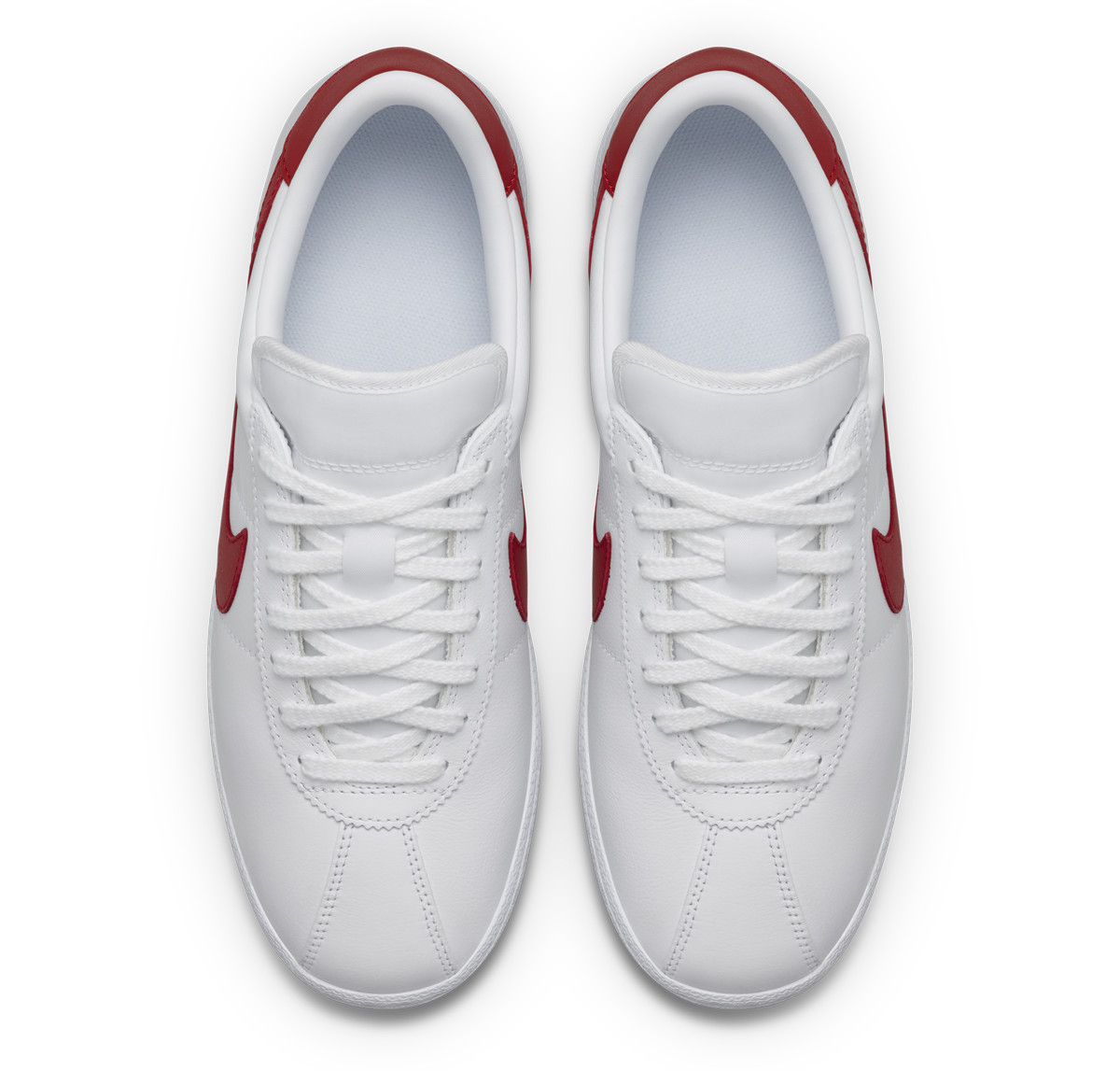 white nike bruin shoes with red swoosh