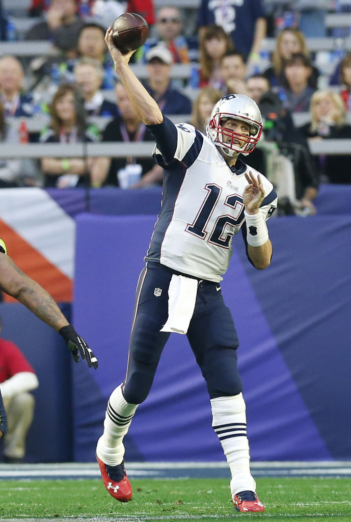 Tom Brady wearing Red Custom Under Armour Cleats for the Super Bowl