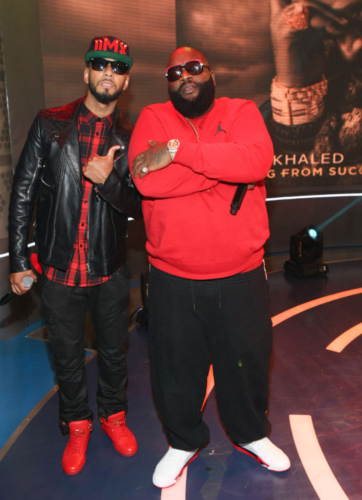 Swizz Beatz wearing Buscemi 100mm; Rick Ross wearing Air Jordan 5 V Retro Fire Red