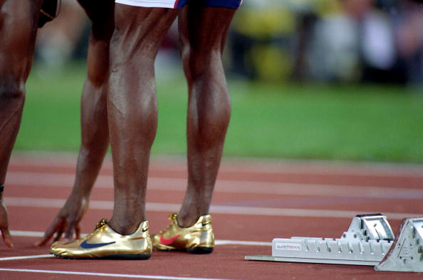 Gold shoes sales olympic runner