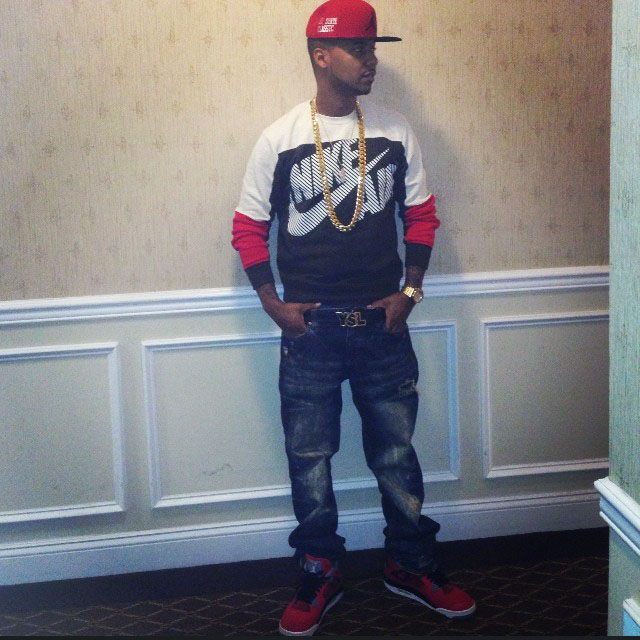 Juelz Santana wearing Air Jordan 4 Retro Toro