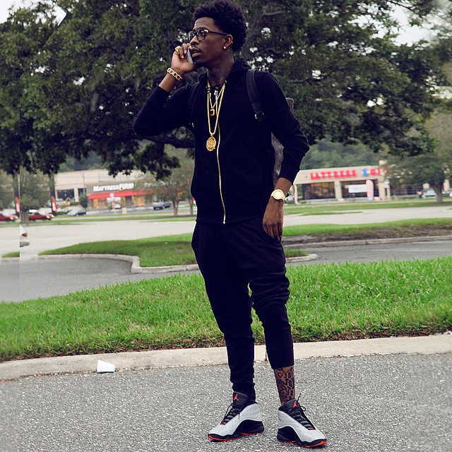 Rich Homie Quan wearing Air Jordan XIII 13 Reflective Silver