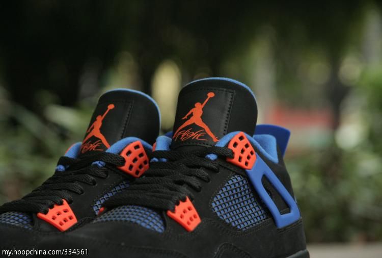 Black and hotsell orange jordan 4