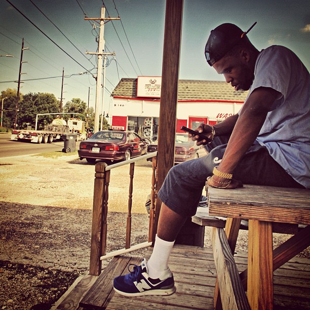 Curren$y wearing New Balance 574