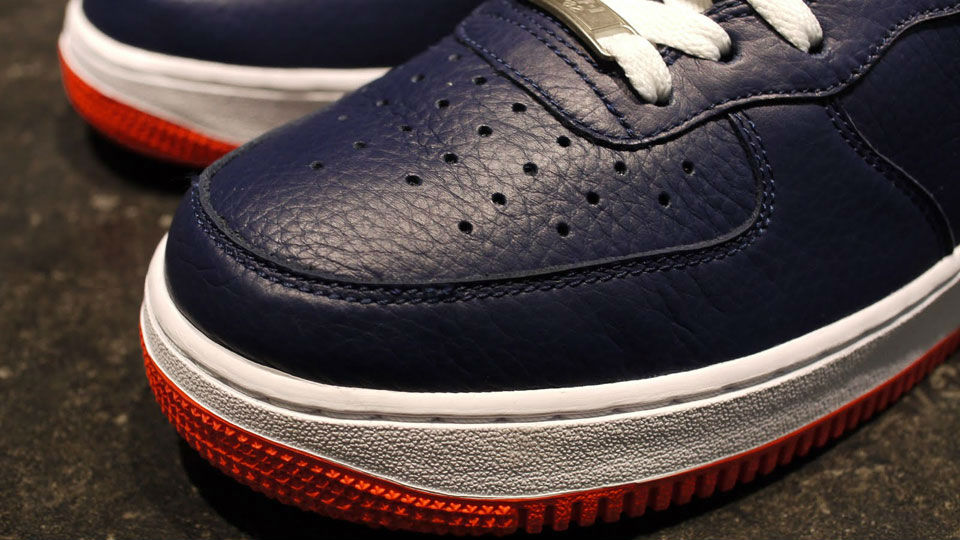 navy blue and orange air force ones