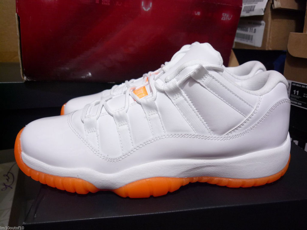 orange and white low top 11s