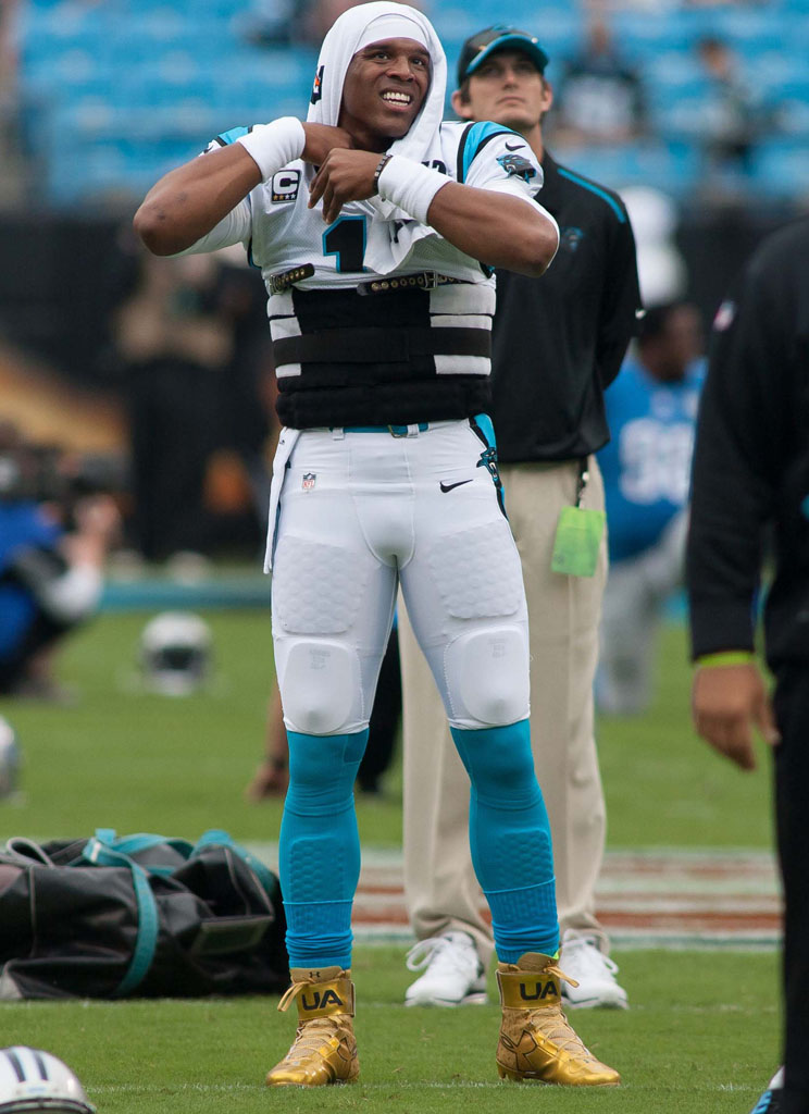 Cam Newton wearing Gold Under Armour Cleats (1)