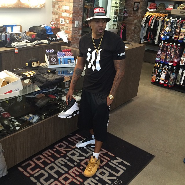 Nas wearing Nike Air Foamposite One Wheat