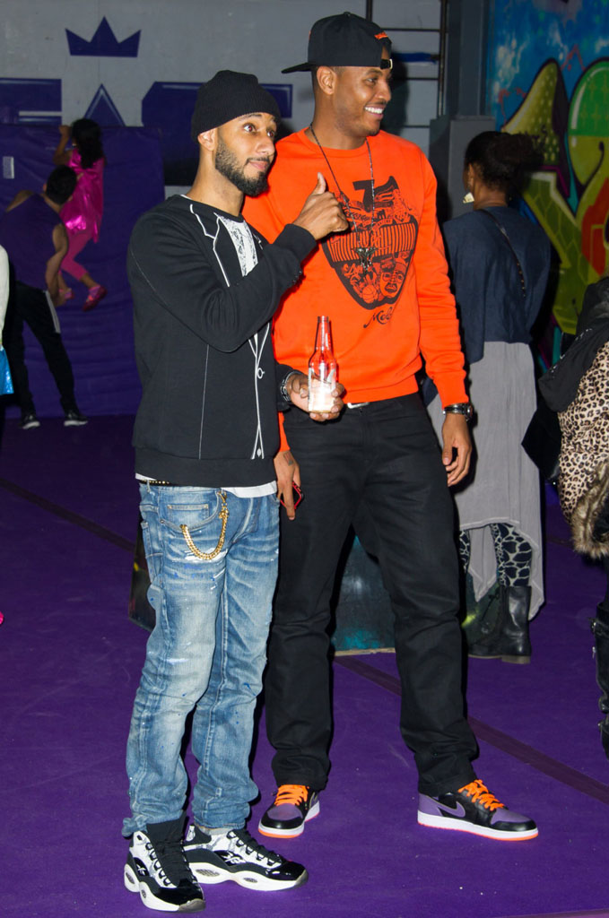 Swizz Beatz wearing BAIT x Reebok Question Snake; Carmelo Anthony wearing Air Jordan 1 I Retro