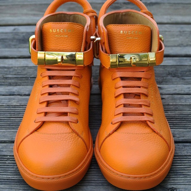 orange designer sneakers