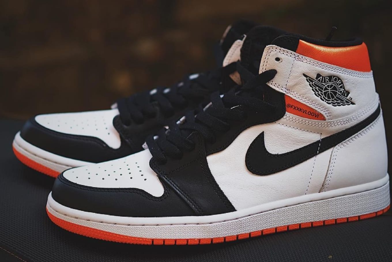 orange black and white air jordan 1s