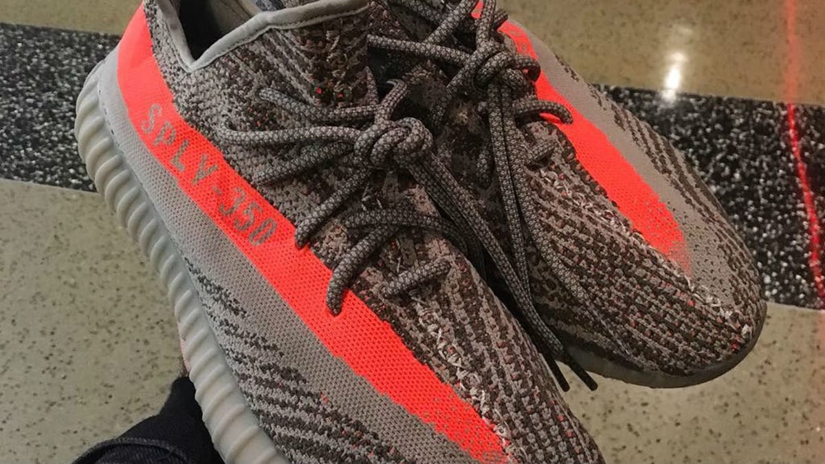 black yeezy with orange stripe