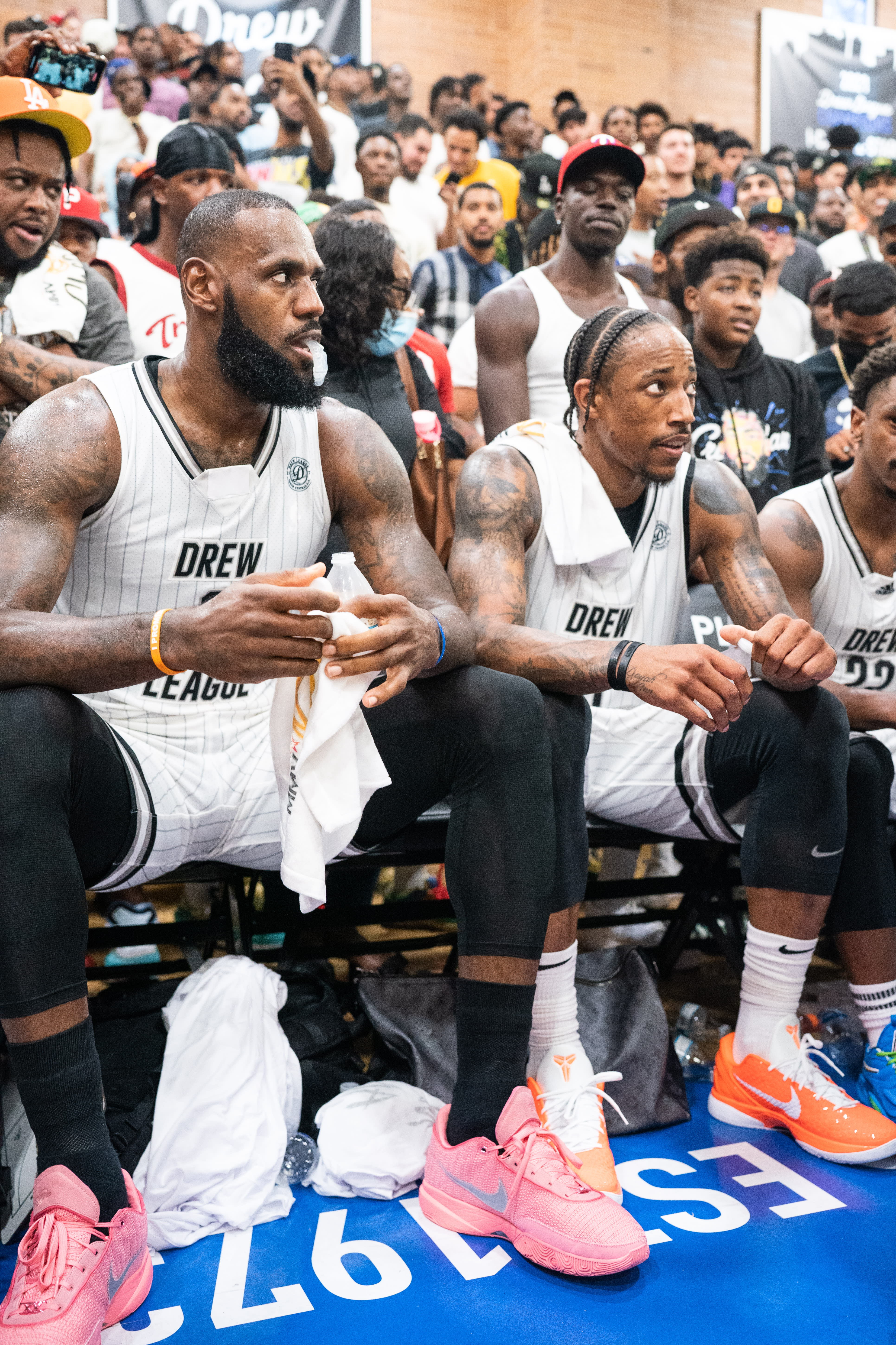 LeBron James and DeMar DeRozan on the Drew League bench on July 16, 2022