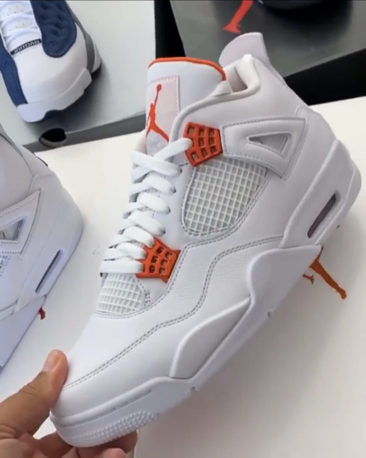 white and orange jordan 4