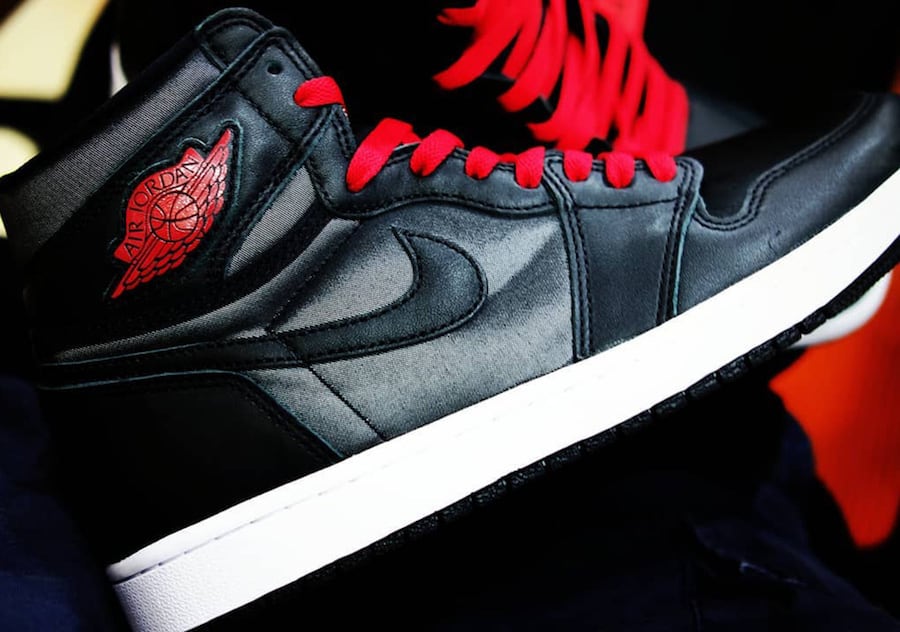 all black jordans with red